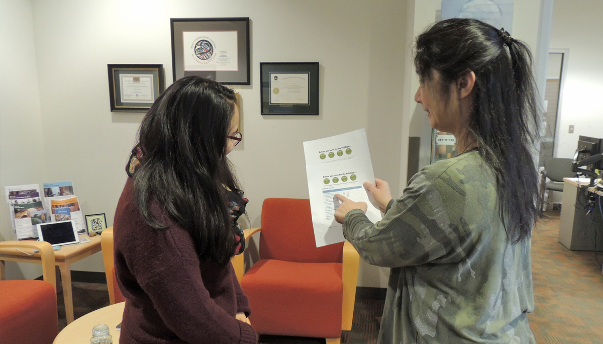 School of Information staff review a checklist