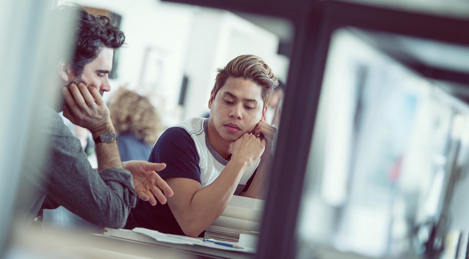 Instructor and student seated in discussion